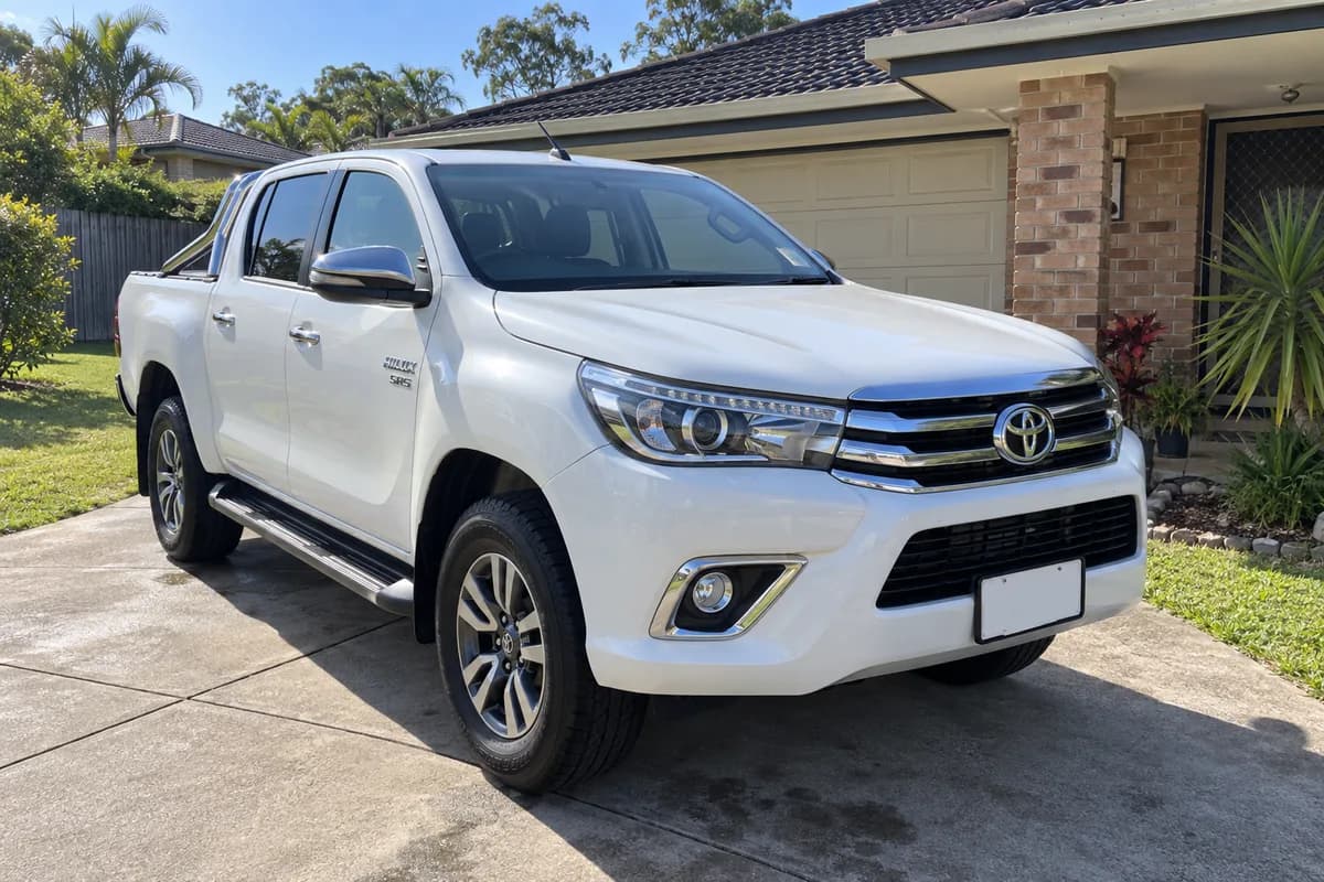 Front three-quarter view of the white HiLux SR5